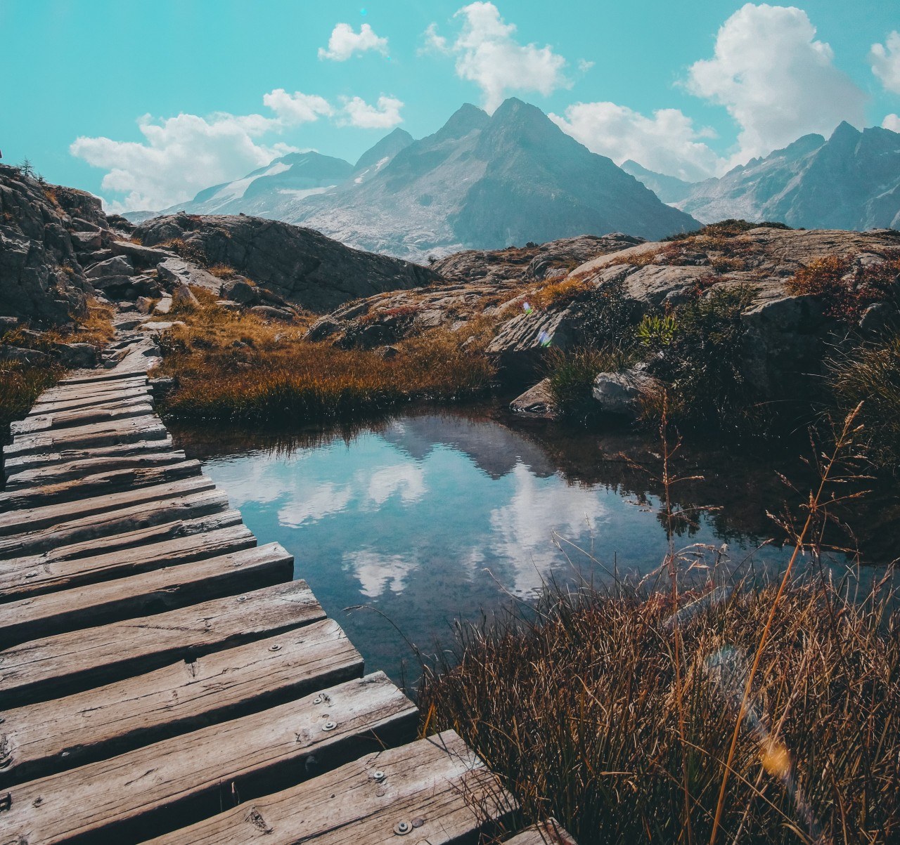 Bridge in pond by mountains